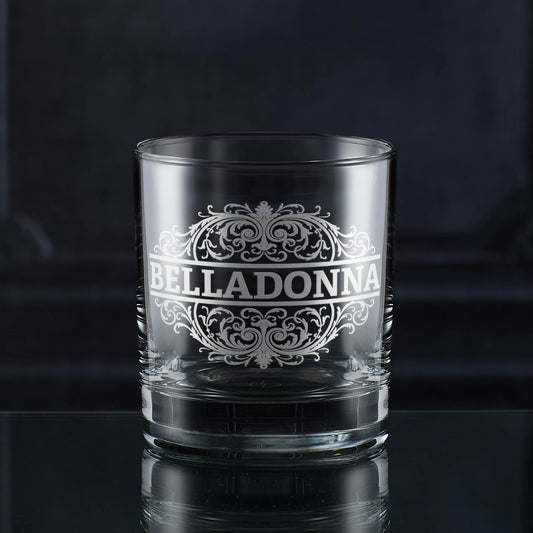 whats your poison whisky glass with 'Belladonna' etched design on a dark background