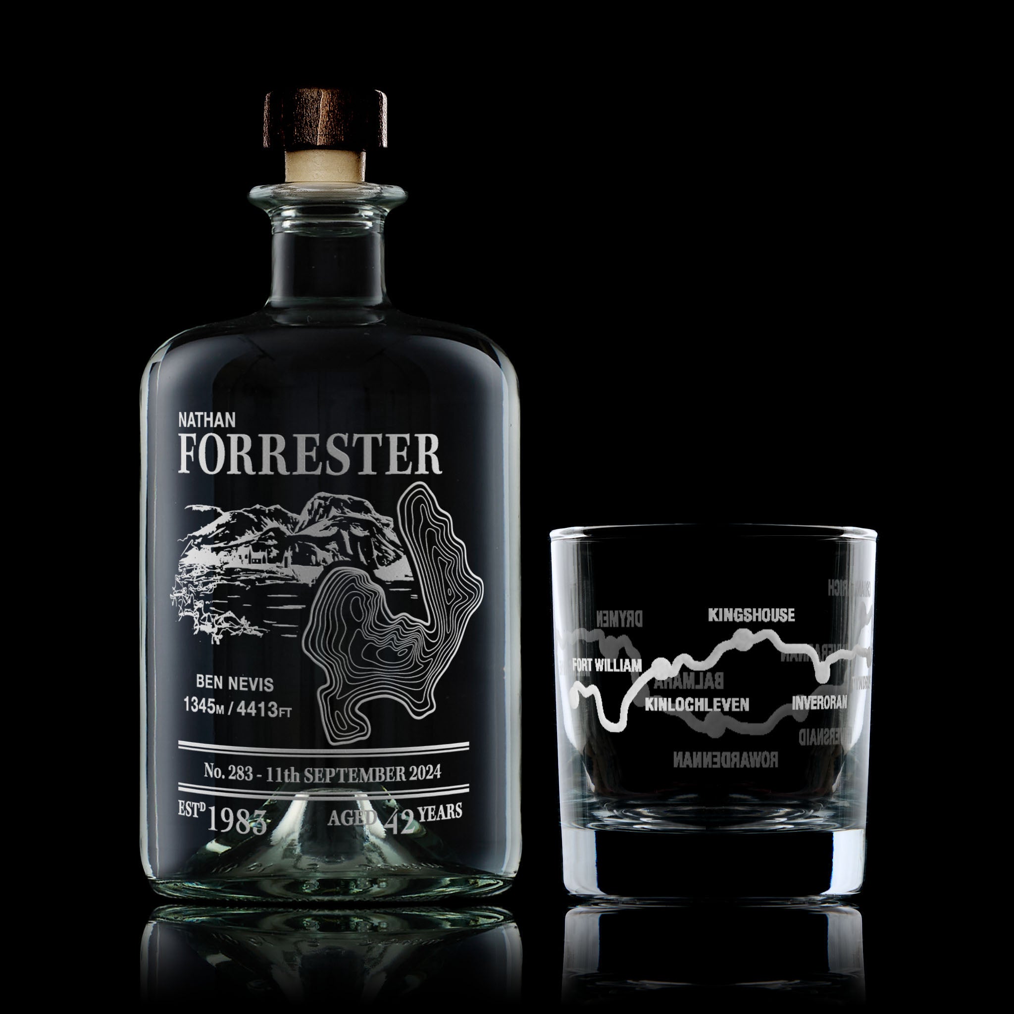 West Highland Way decanter and whisky glass engraved with Ben Nevis, photographed on a black background