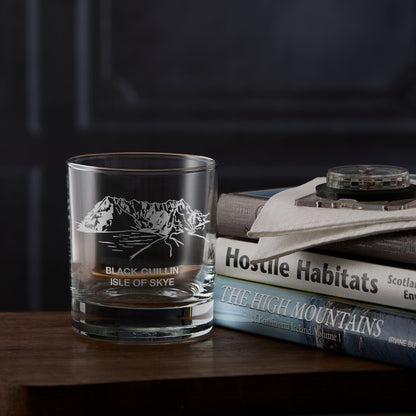 Isle of Skye whisky glass with engraved illustration of the Black Cuillin, next to a stack of mountain books