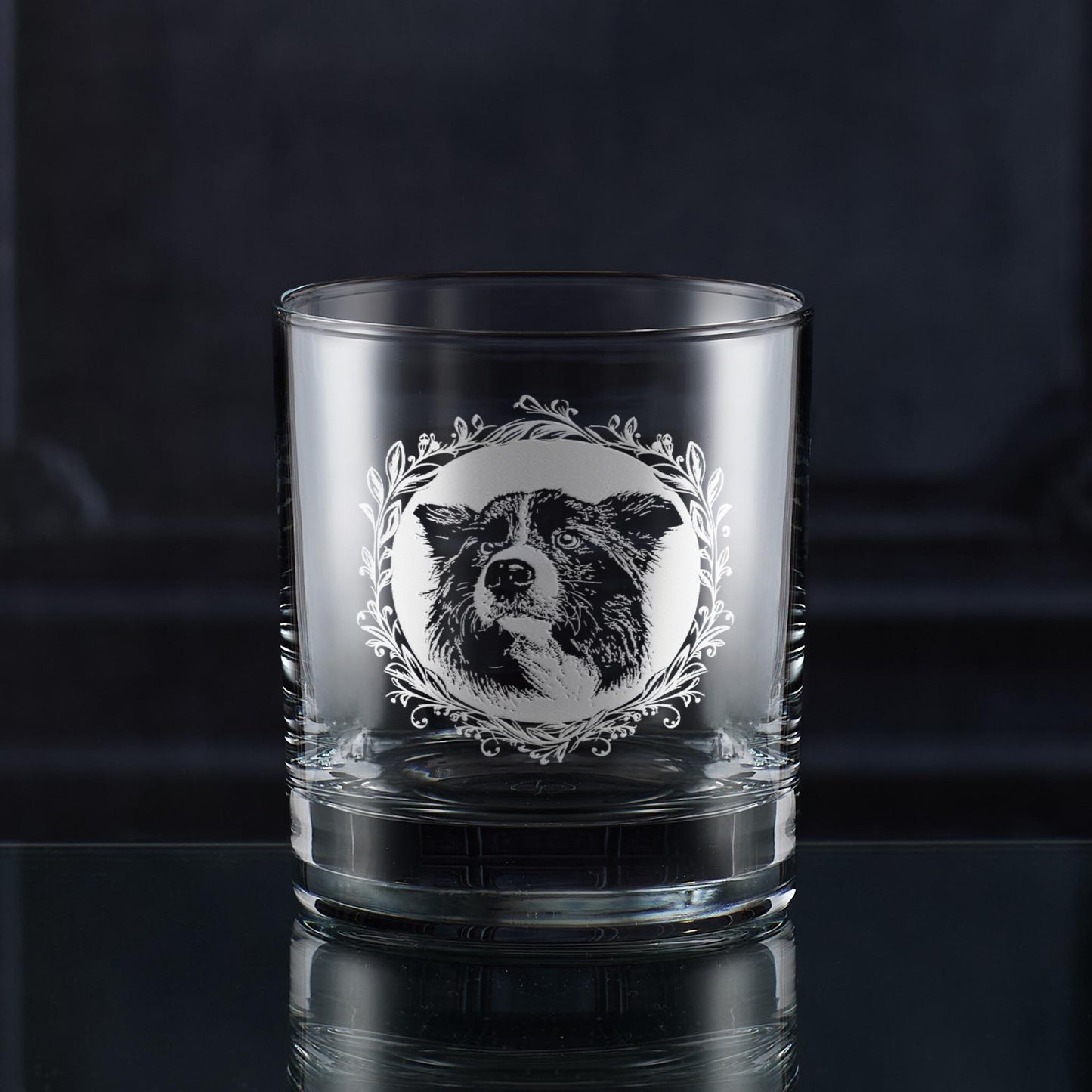 Engraved Border Collie whisky glass with two portrait variations framed by a leafy garland, hand-engraved in Scotland by Just The Ticket.