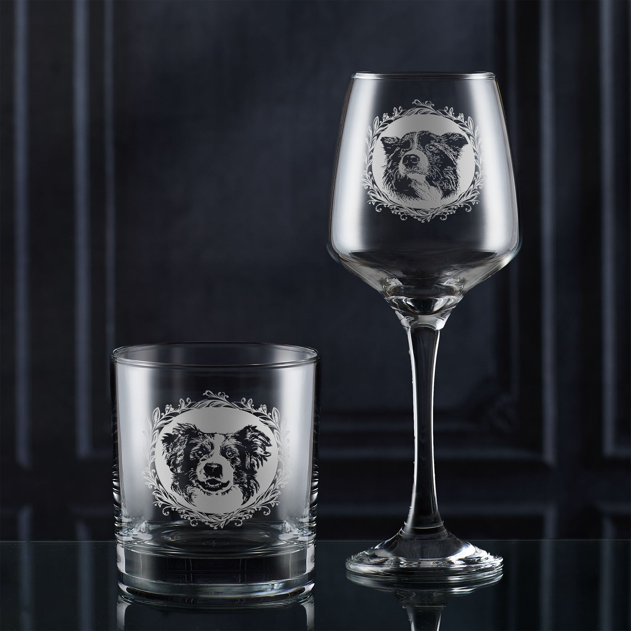 Wine glass and tumbler with engraved dog design on a dark background