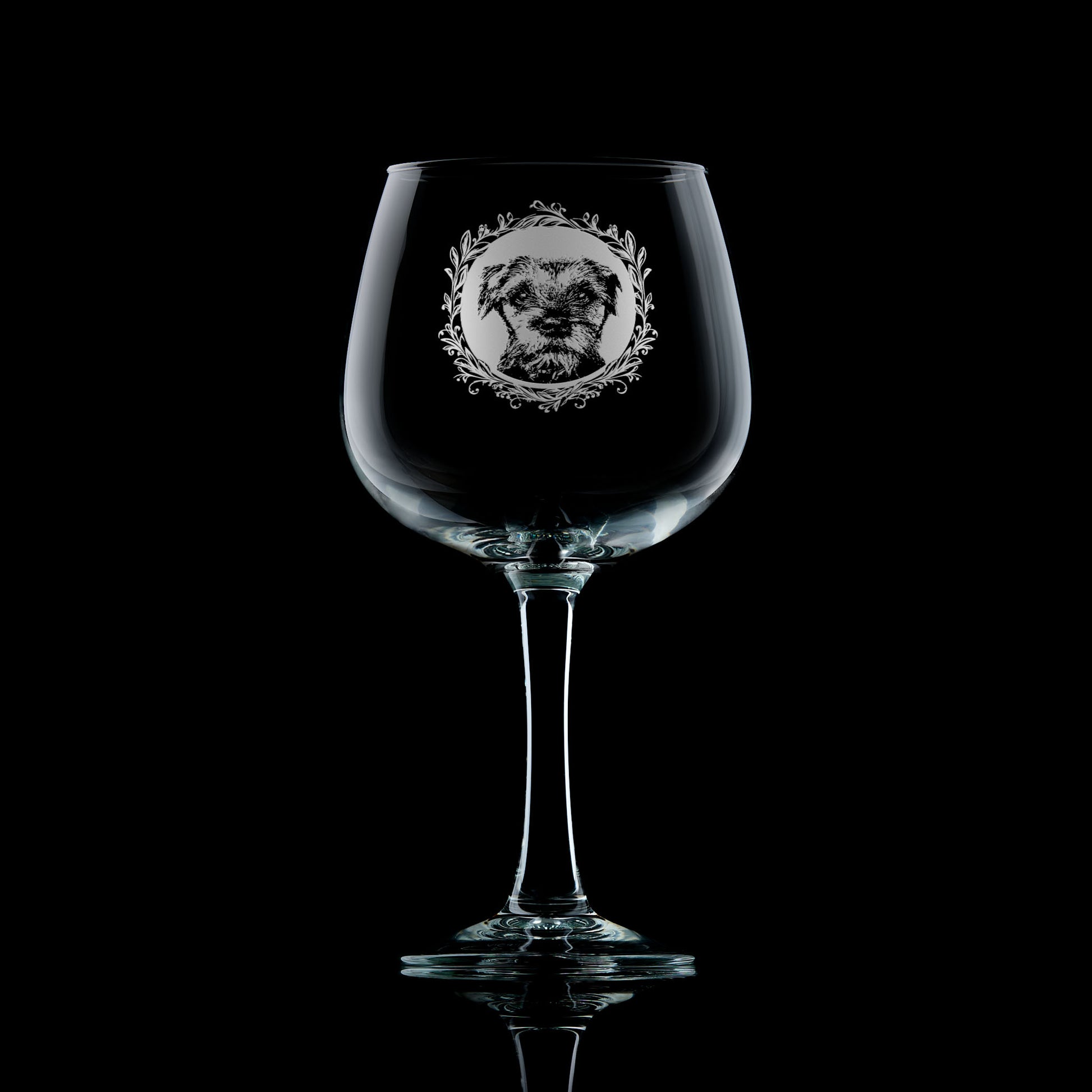 Gin glass with engraved border terrier portrait in circular frame with leafy garland