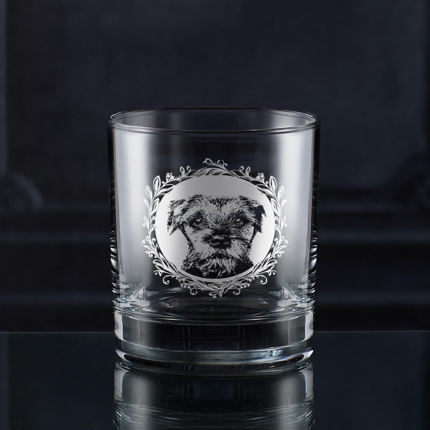 Engraved Border Terrier wine glass with a straight-on dog portrait framed by a leafy garland, hand-engraved in Scotland by Just The Ticket.