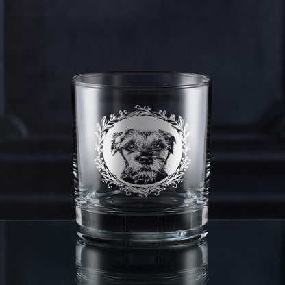 Engraved Border Terrier wine glass with a straight-on dog portrait framed by a leafy garland, hand-engraved in Scotland by Just The Ticket.