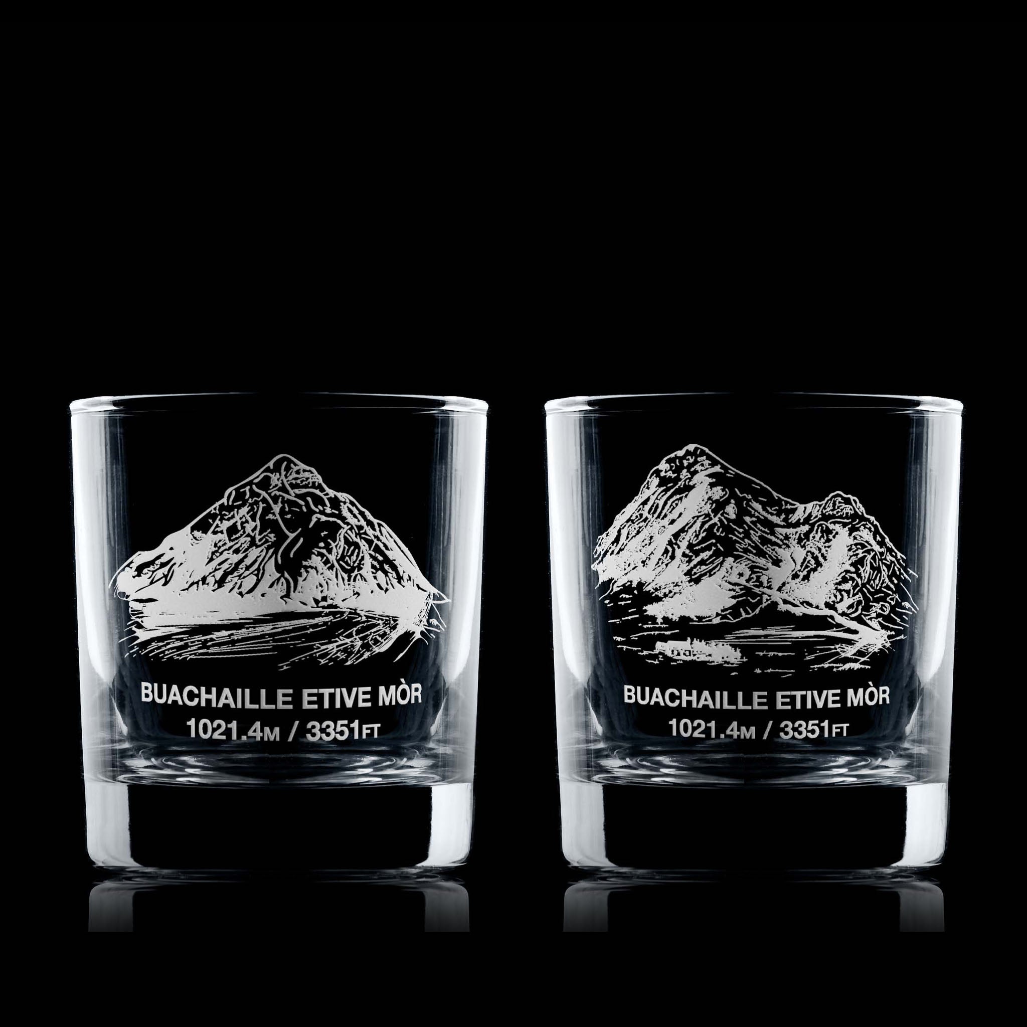 Pair of whisky glasses engraved with Buachaille Etive Mòr, photographed on a dark background