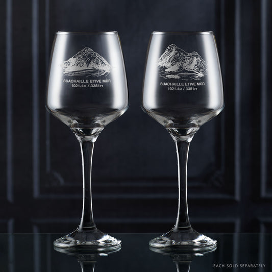 Two wine glasses with Buachaille Etive Mor mountain etching on a dark background 