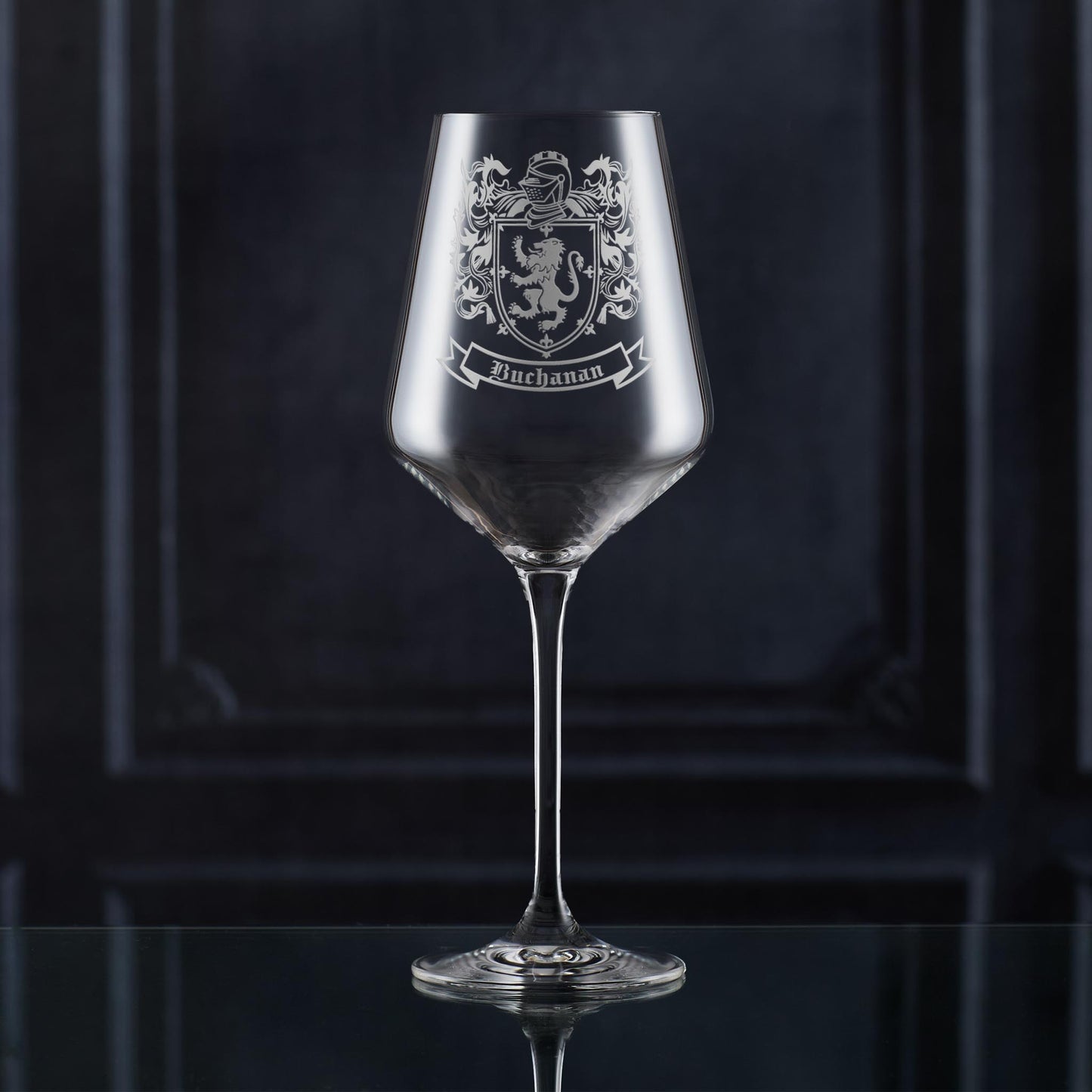 Crystal-style wine glass with Buchanan coat of arms — deep etch, ideal for milestone gifts.