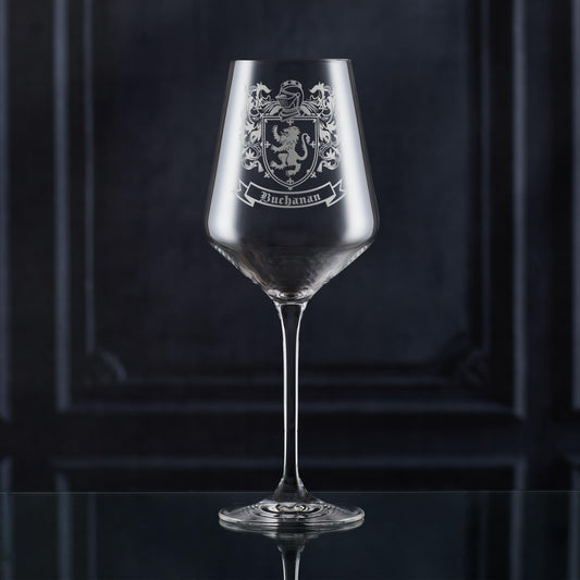 Crystal-style wine glass with Buchanan coat of arms — deep etch, ideal for milestone gifts.