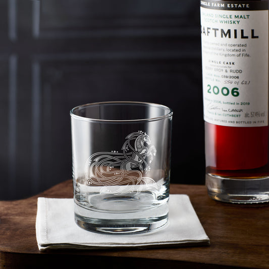 Personalised whisky glass with horse engraving on a wooden surface