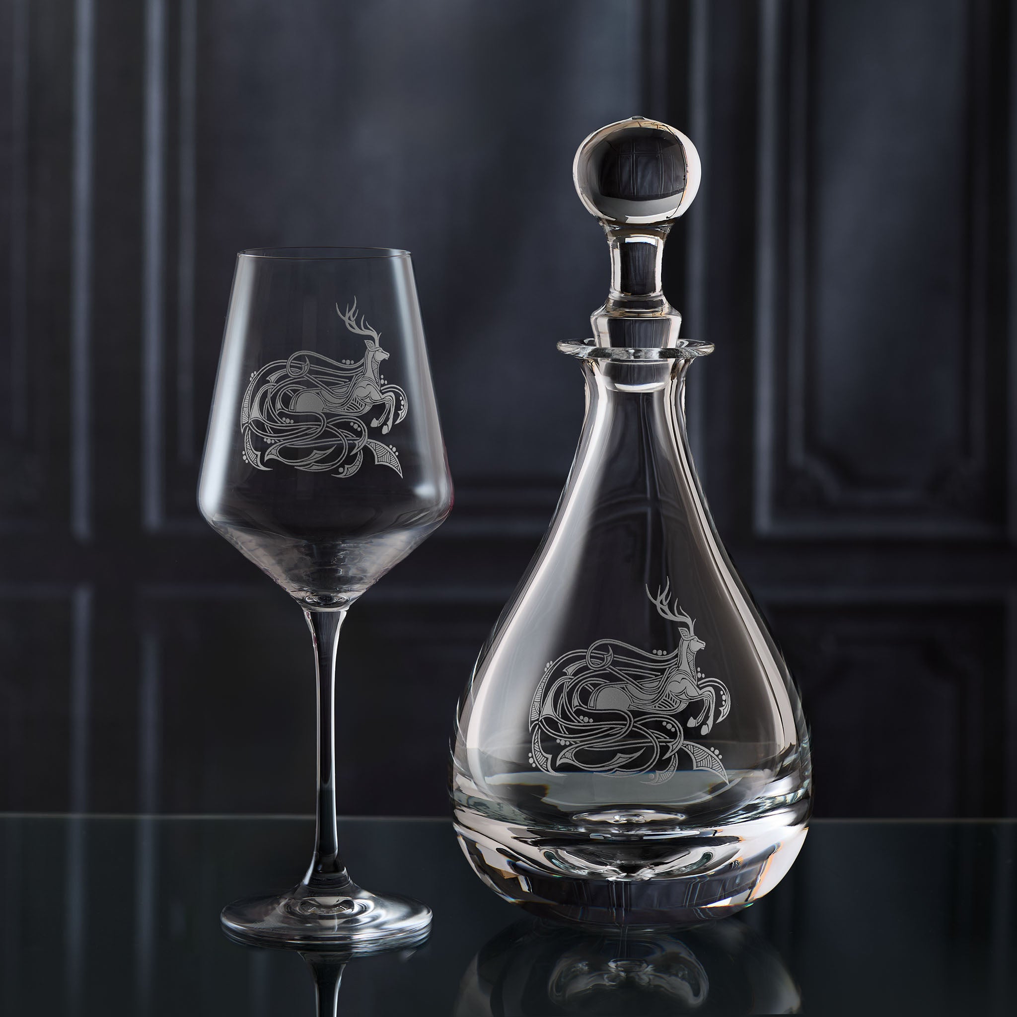 Engraved Scottish decanter and stag wine glass on a dark background