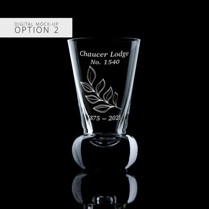 Clear firing glass with engraved text and design on a black background