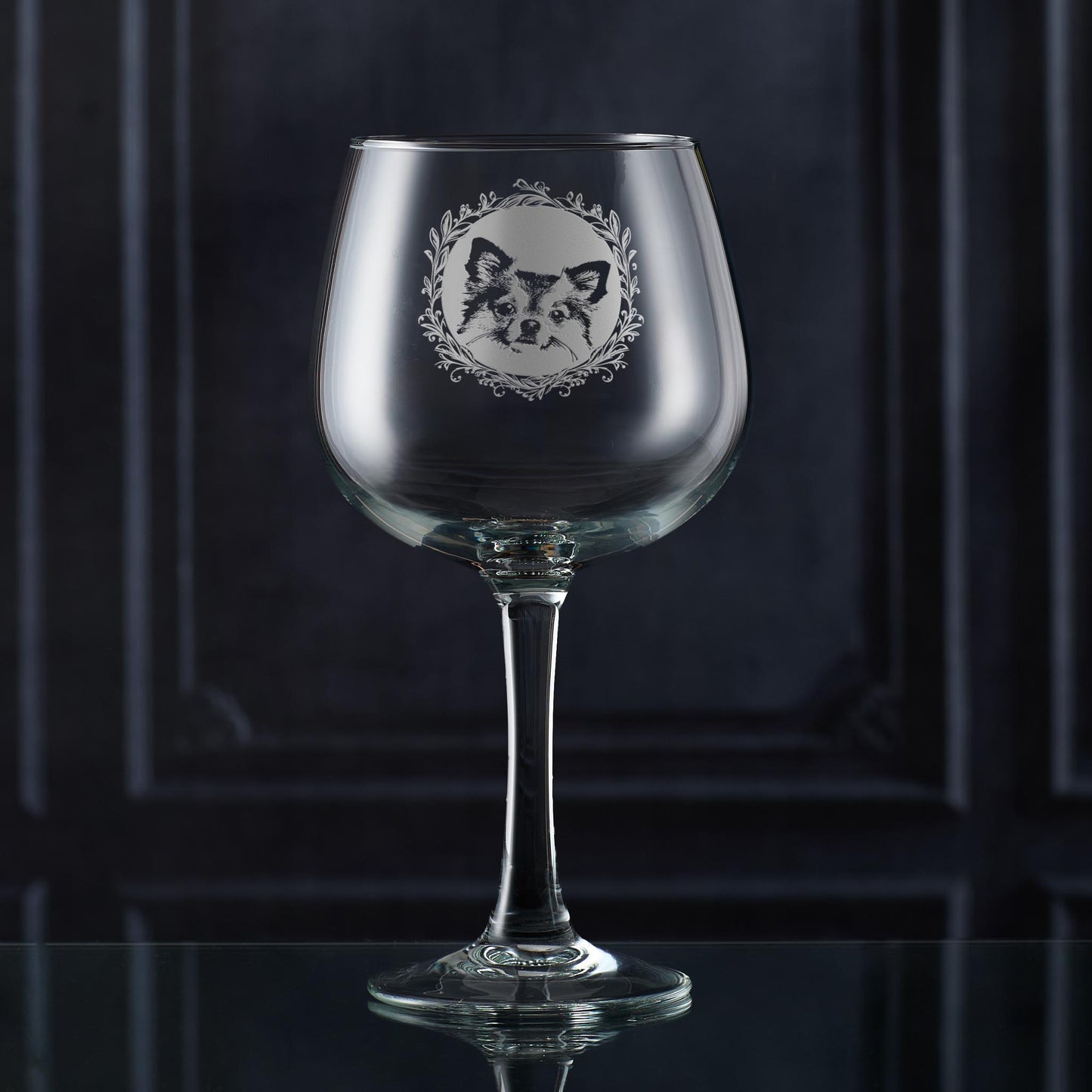 Gin glass with engraved longhaired chihuahua portrait in circular frame with leafy garland