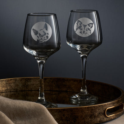 Two wine glasses each engraved with a portrait of a chihuahua