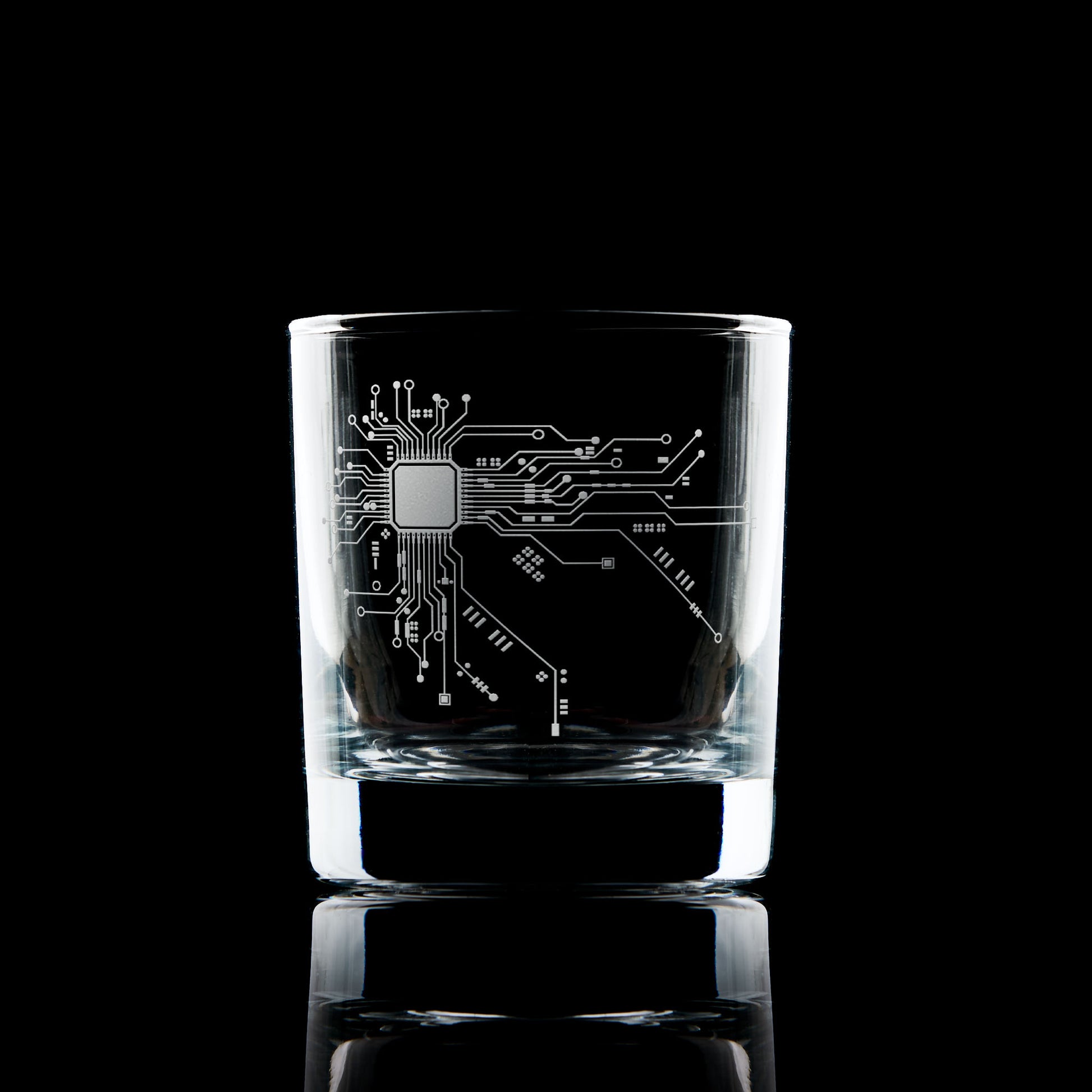 Engraved whisky glass with circuit board design, tech-inspired