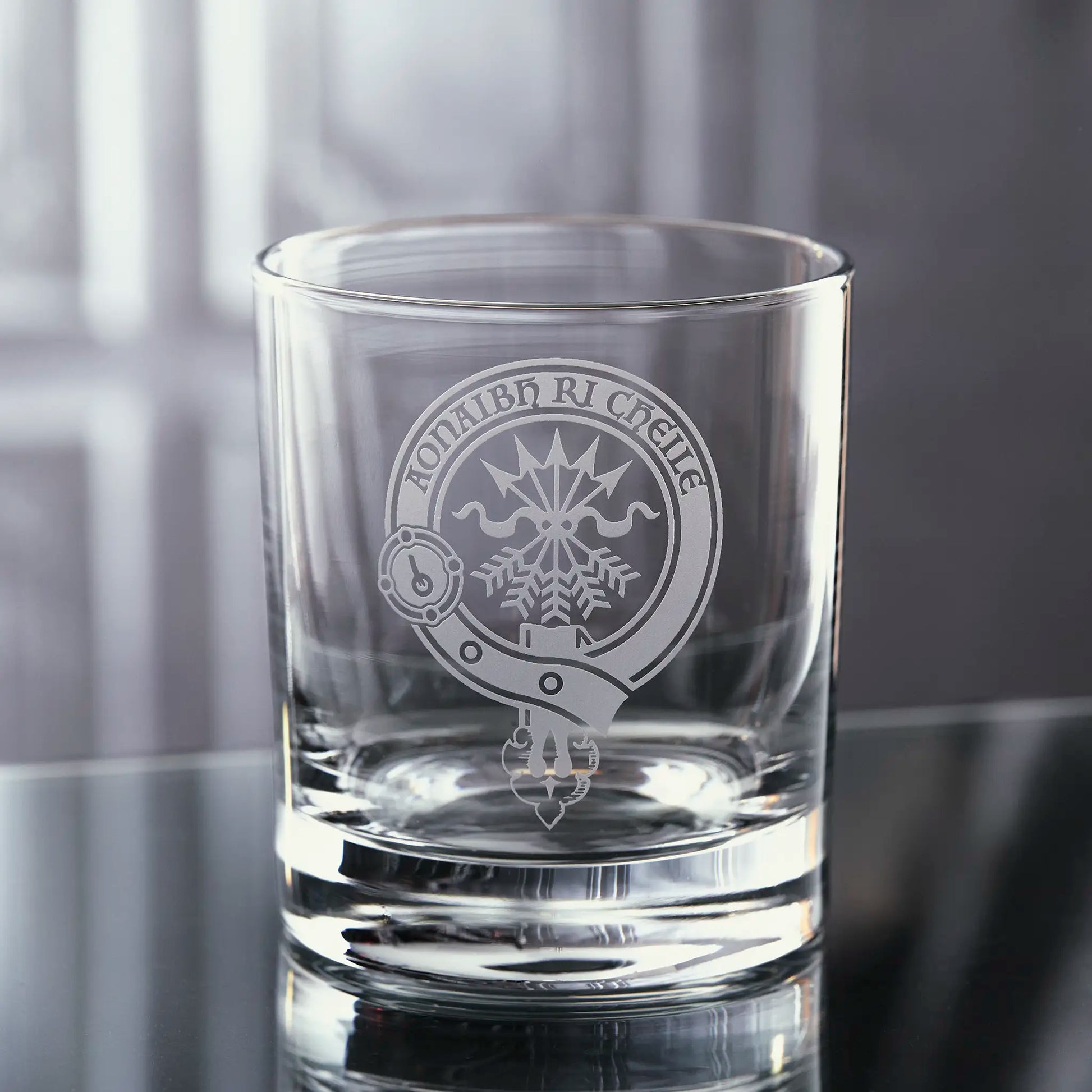 whisky tumbler engraved with the Cameron family clan crest surrounded by a scottish belt and buckle