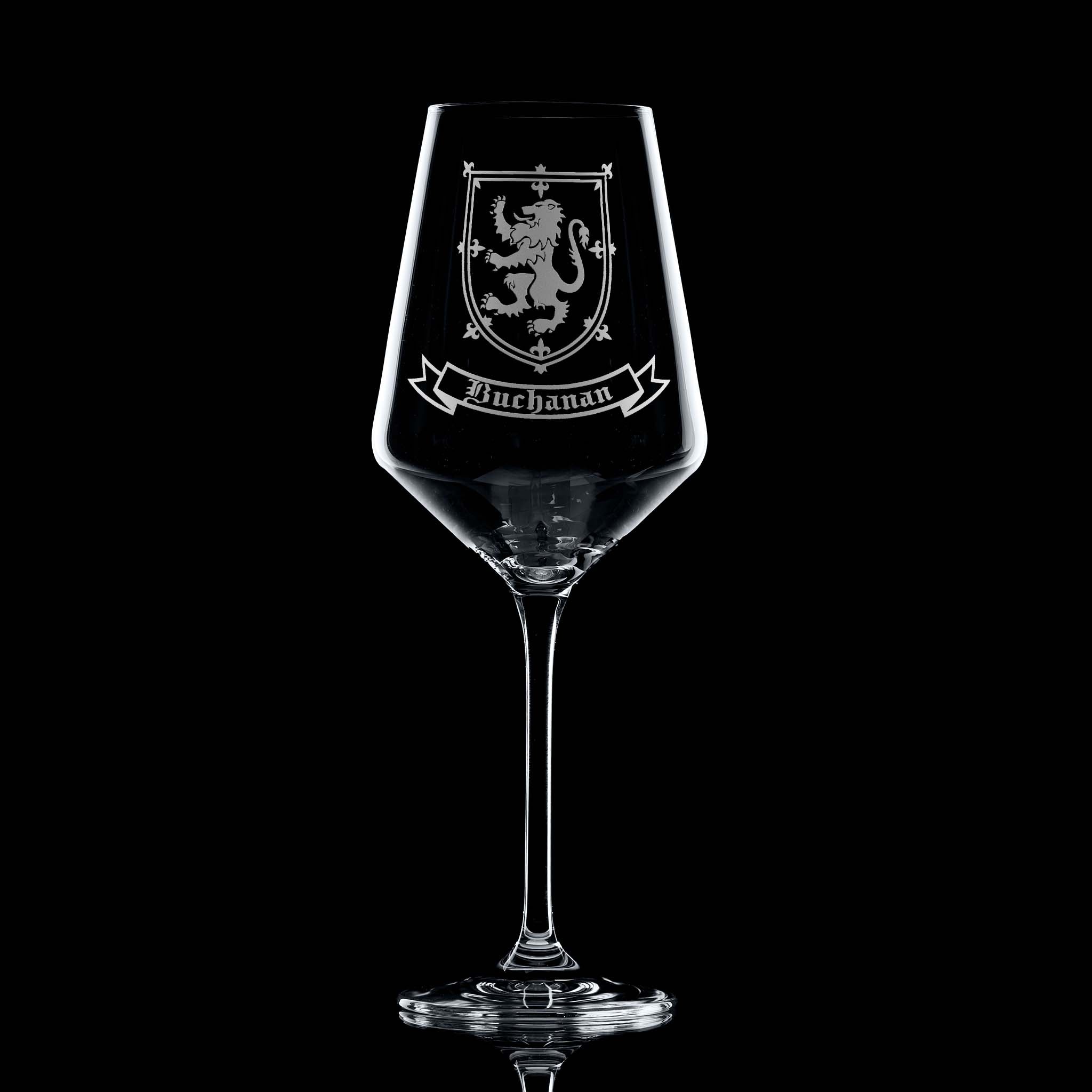 Wine glass with engraved family crest and name on a black background