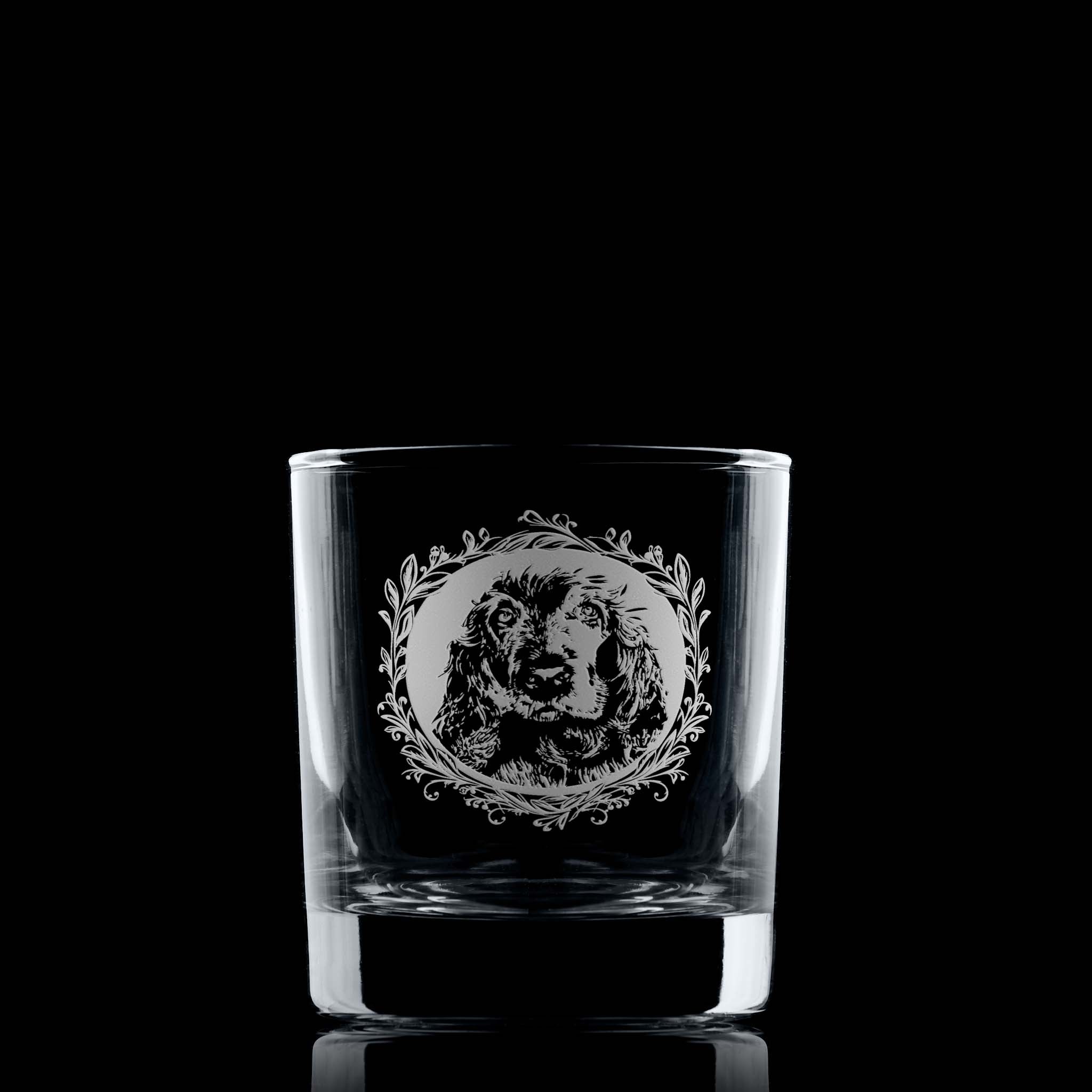Whisky glass with engraved show cocker spaniel portrait in circular frame with leafy garland