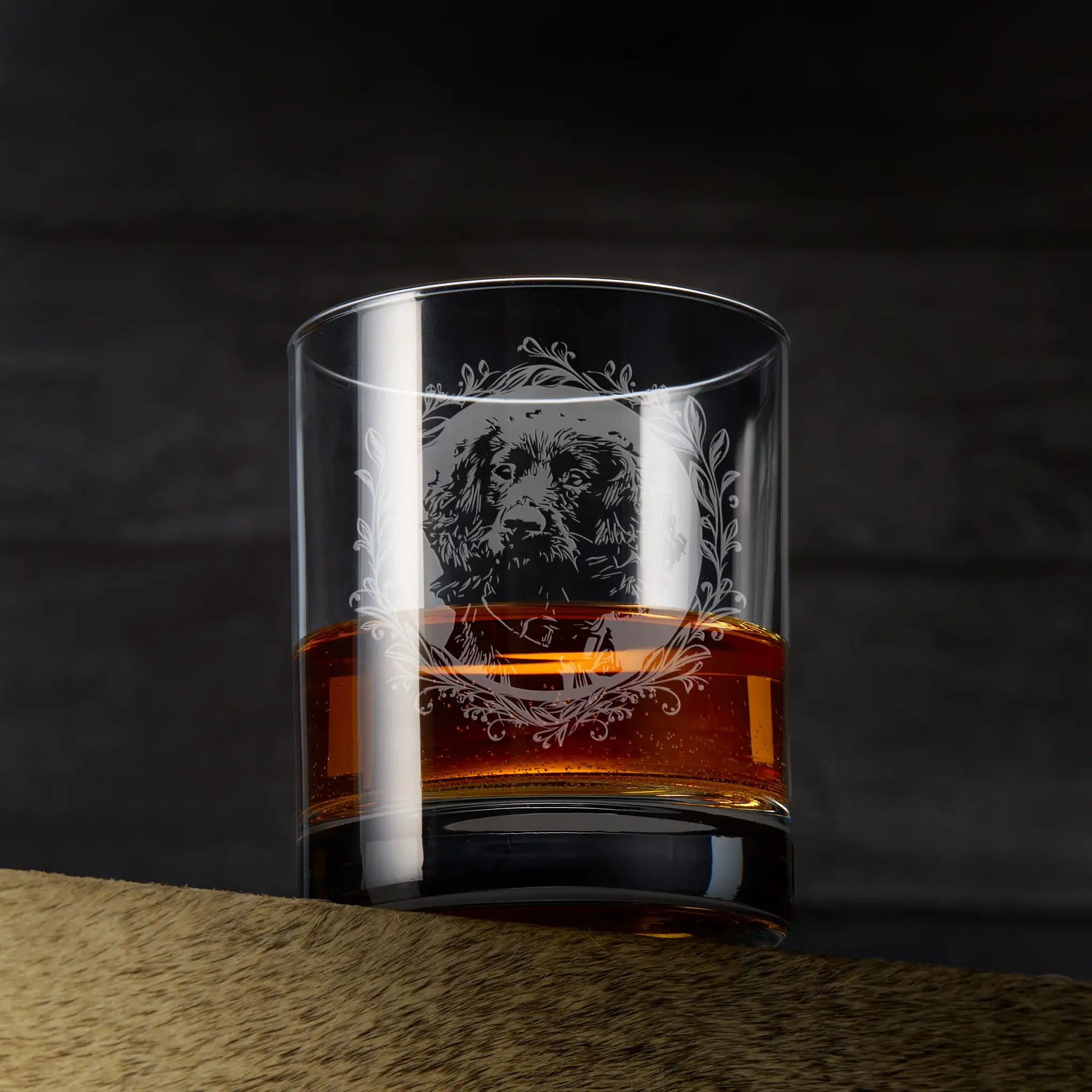 Whiskey glass with engraved working cocker spaniel framed with leafy garland