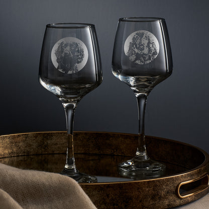 Two wine glasses engraved with portraits of a show cocker and a working cocker spaniel