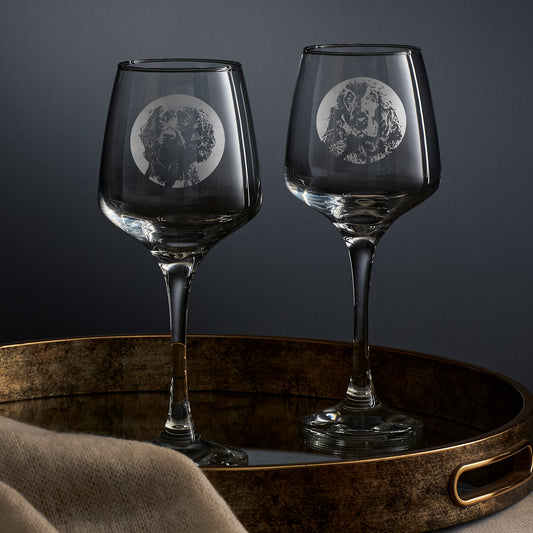 Two wine glasses engraved with portraits of a show cocker and a working cocker spaniel