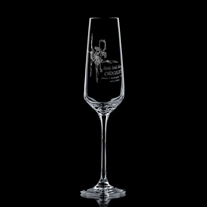 Clear glass champagne flute with engraved corporate logo design on a black background