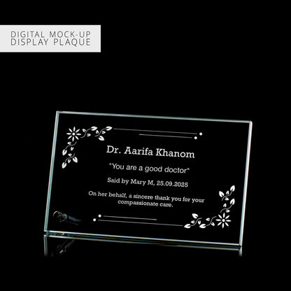 Digital mock-up of a glass plaque with engraved text on a black background