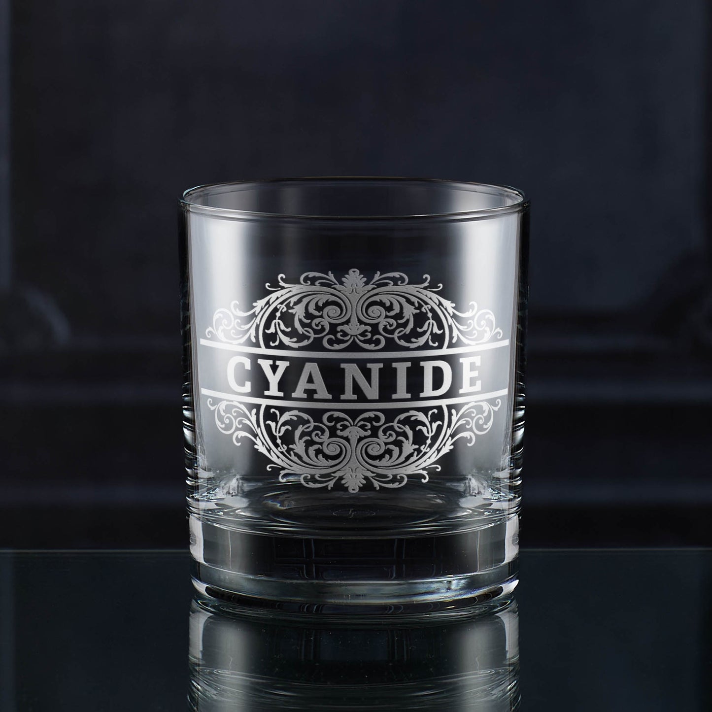 Whisky glass engraved with a Cyanide poison-label design inspired by Victorian apothecaries.