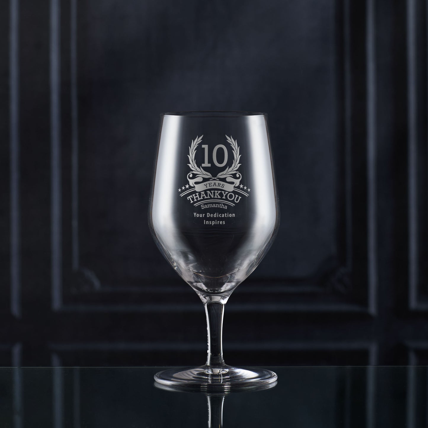 Engraved whisky glass with ‘10’ inside laurel wreath, six stars, and curved name/message