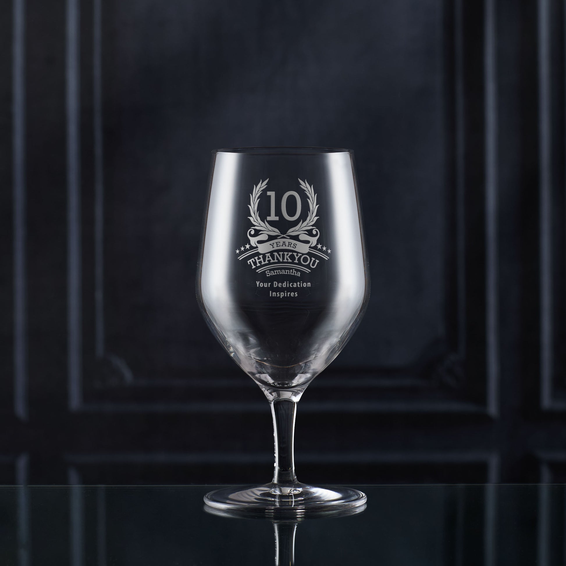 Engraved whisky glass with ‘10’ inside laurel wreath, six stars, and curved name/message