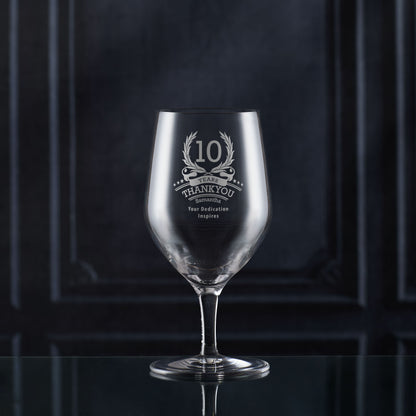 Engraved whisky glass with ‘10’ inside laurel wreath, six stars, and curved name/message