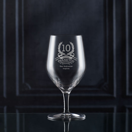 Engraved whisky glass with ‘10’ inside laurel wreath, six stars, and curved name/message