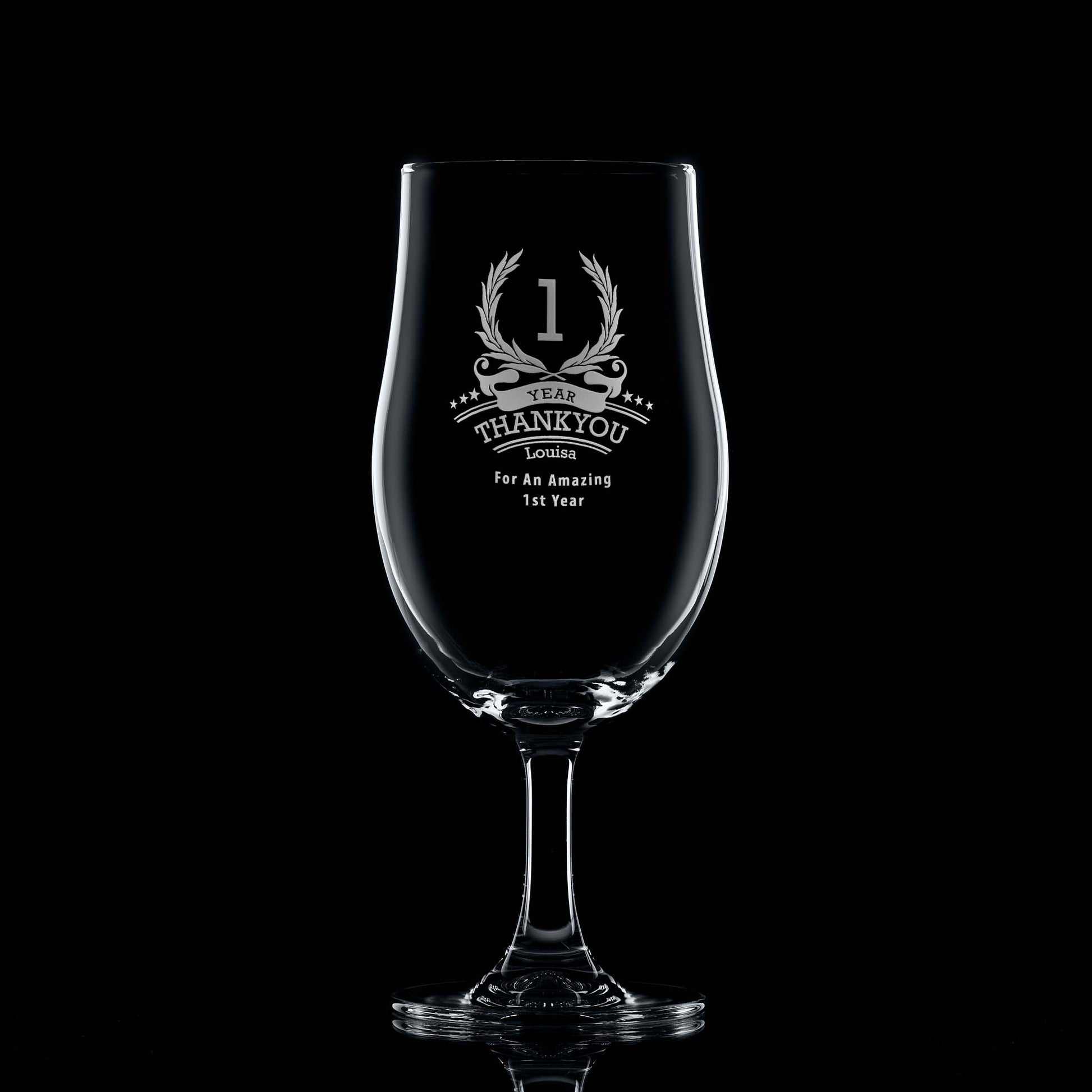 Engraved beer glass with ‘1’ inside a laurel wreath, six stars, recipient name, and club message