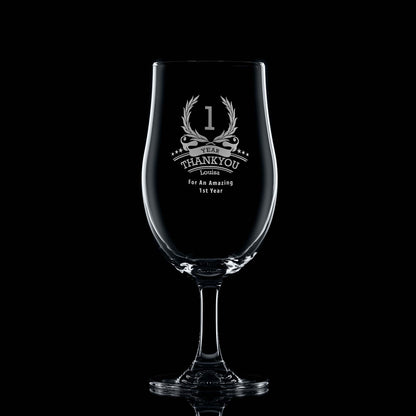 Engraved beer glass with ‘1’ inside a laurel wreath, six stars, recipient name, and club message