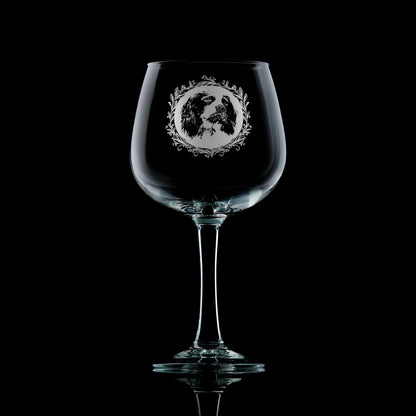 Large gin glass with engraved springer spaniel design on a black background