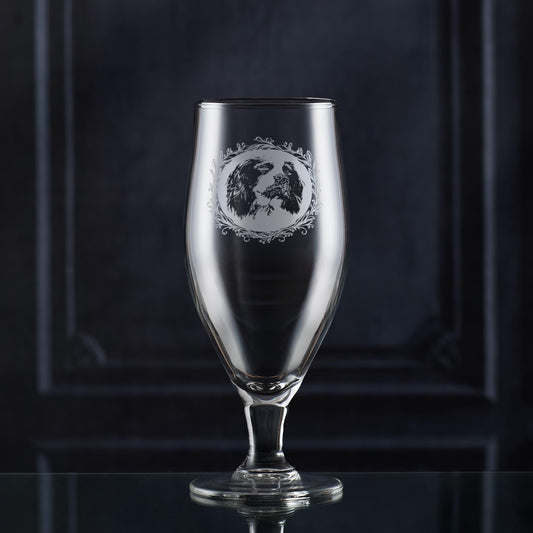 Stemmed beer glass with engraved english springer spaniel framed with a leafy garland