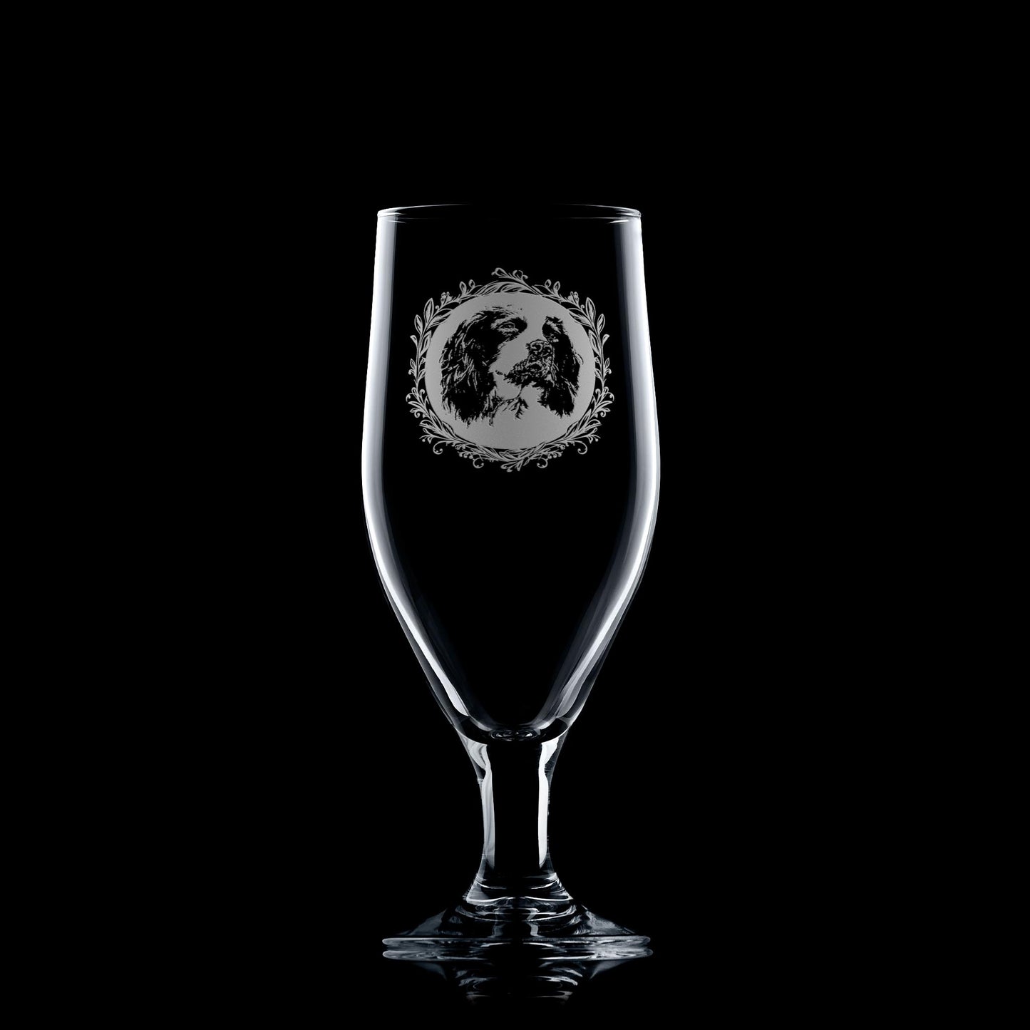 Beer glass engraved with a portrait of a Springer Spaniel on a black background