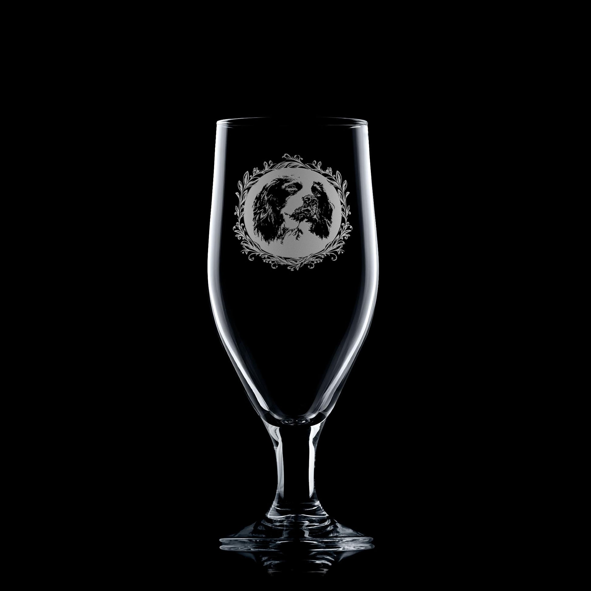 Beer glass engraved with a portrait of a Springer Spaniel on a black background