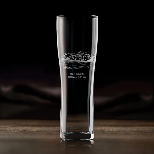 Pint glass engraved with Ben Nevis, photographed in situ on a wooden surface