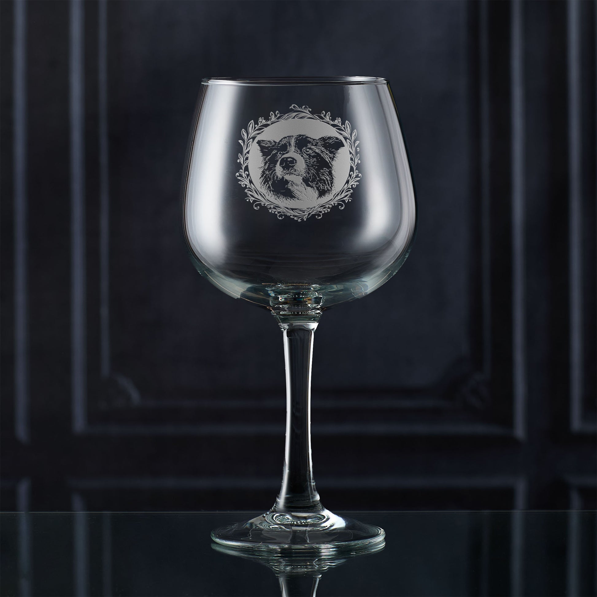 Engraved Border Collie gin glass surrounded by a leafy garland and hand-engraved in Scotland by Just The Ticket.