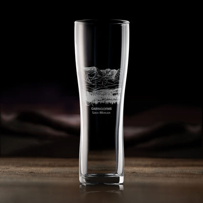 Engraved pint glass with Cairngorms and Loch Morlich landscape, shown on dark background to highlight engraving