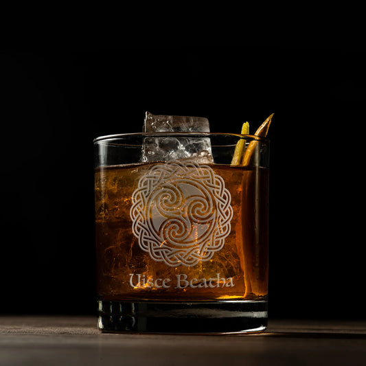 Glass tumbler engraved with Uisce beatha, the Irish Gaelic name for Irish whiskey and celtic knotwork