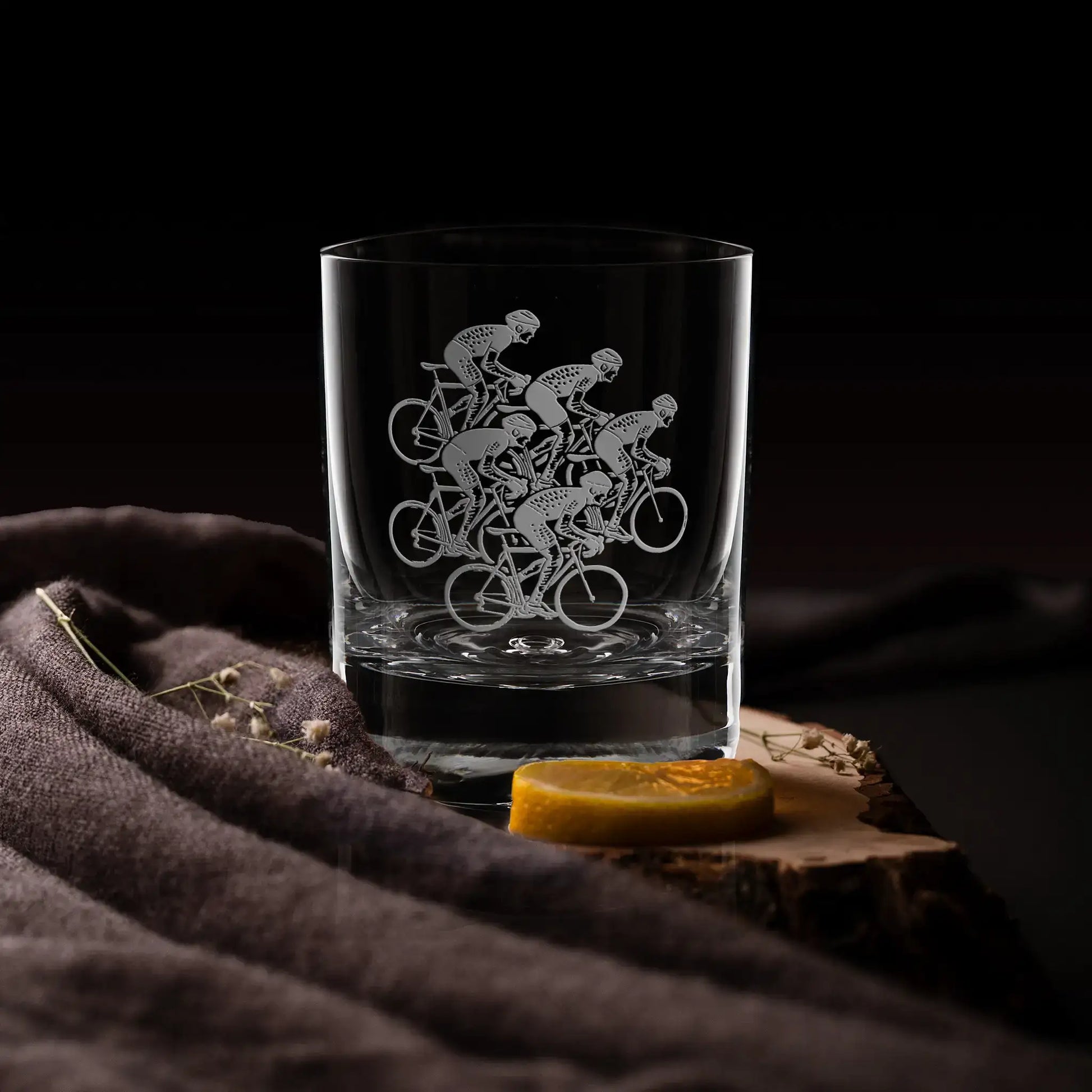 Whisky glass engraved with five cyclist silhouettes, personalised cycling gift.