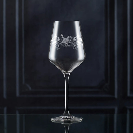 Atelier wine glass engraved with December birth flowers — holly, narcissus and wren.