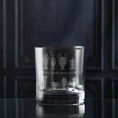 Whisky Glass with eight football trophy sillhouettes on a dark background
