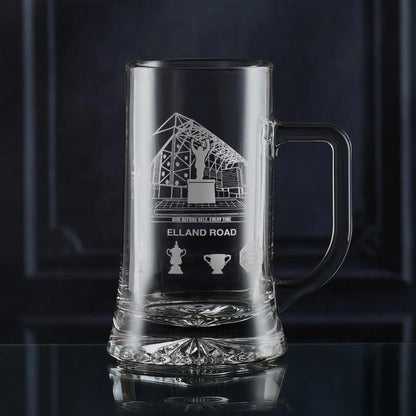 Engraved tankard featuring line-art architectural interpretation of Elland Road with trophy silhouettes beneath.