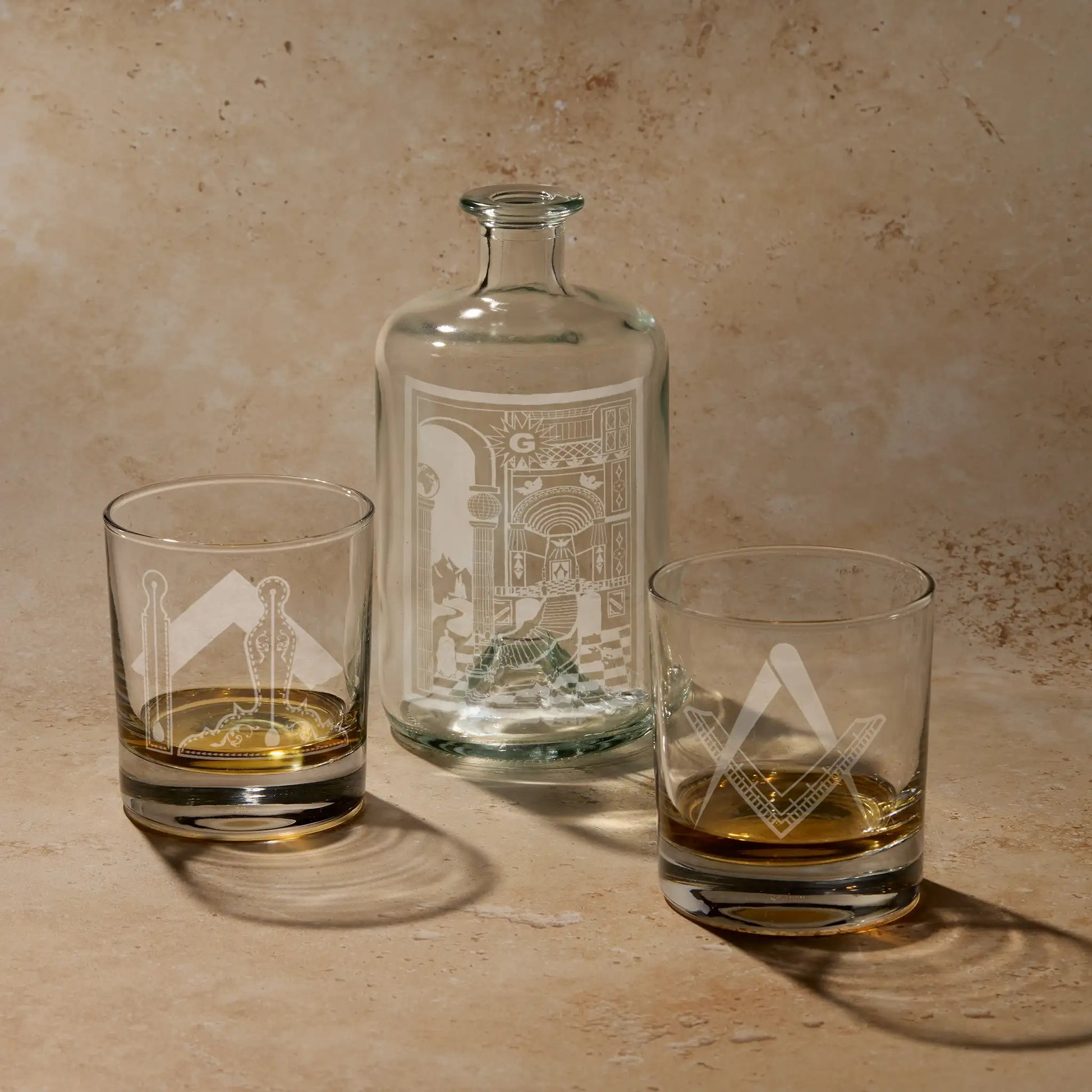 Fellowcraft 2nd Degree gift set featuring engraved apothecary decanter bottle with tracing board design and two whisky glasses with Square and Compass and working tools.