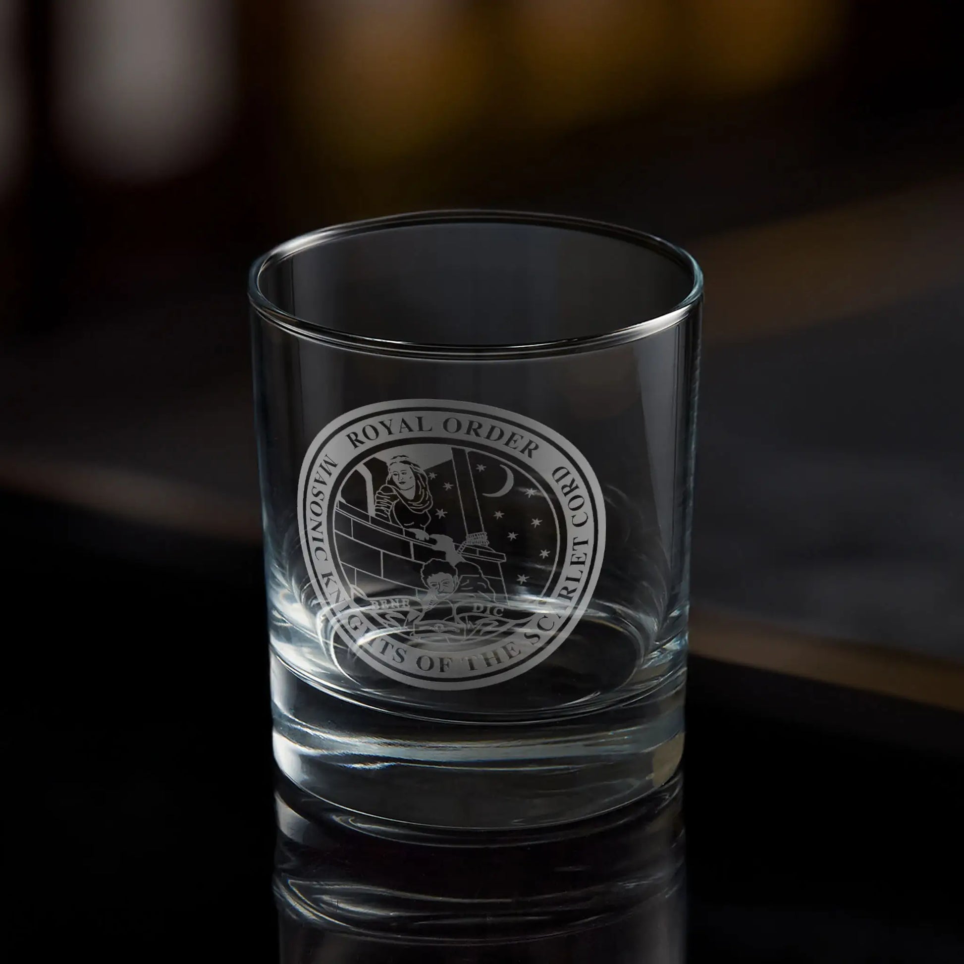 Masonic whisky tumbler with engraved Order of the Scarlet Cord emblem on a dark background