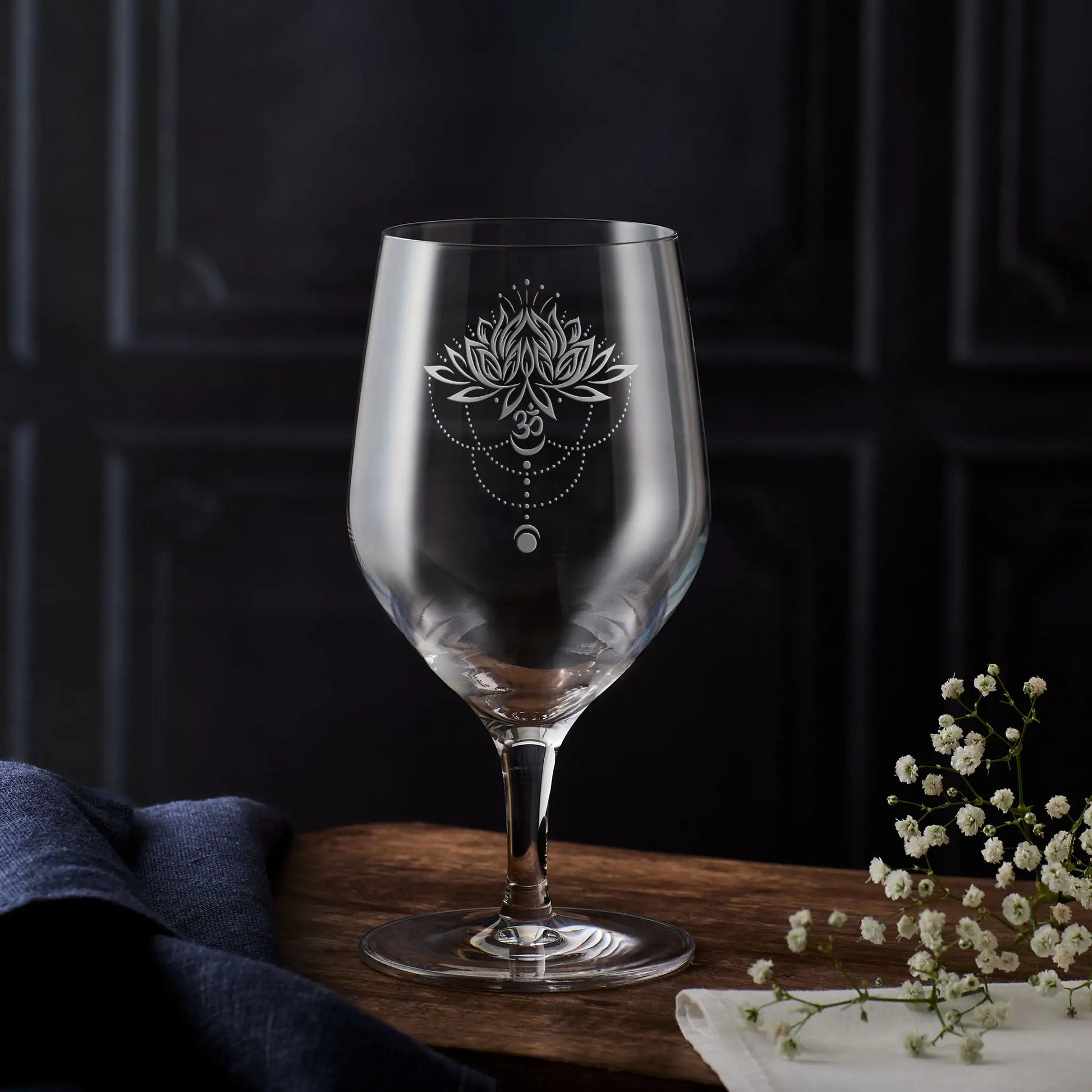 Engraved mineral water glass with lotus flower, Om symbol, moon phases and dotted mandala detail 