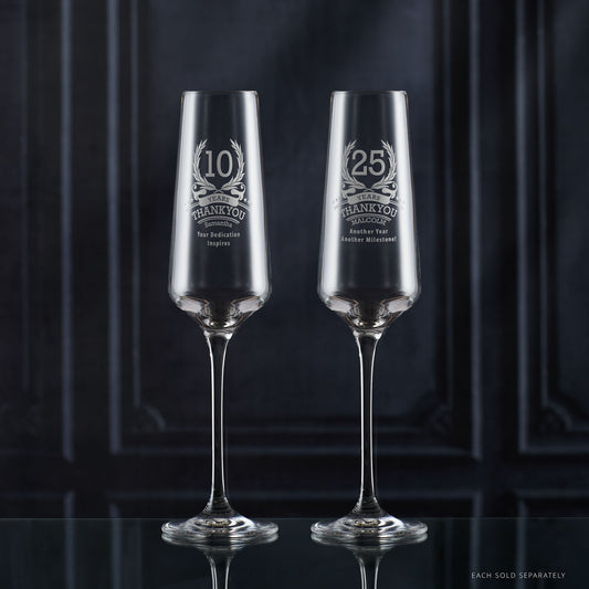 Two champagne flutes engraved with ‘10’ inside laurel wreath, stars, and personalised message