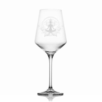 Yoga wine glass engraved with a lotus flower and woman sitting cross legged on a white background